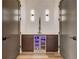 Temperature controlled wine room with custom cabinetry and LED lighting at 330 Heatherden Ave, Fayetteville, GA 30214