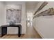 Long hallway with hardwood floors, large artwork, and a modern console table at 330 Heatherden Ave, Fayetteville, GA 30214