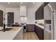 Modern kitchen with dark cabinetry, quartz countertops, and high-end appliances at 330 Heatherden Ave, Fayetteville, GA 30214