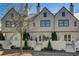 Three story townhouses with arched entryways and brick detailing at 330 Heatherden Ave, Fayetteville, GA 30214