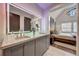 Bathroom with double vanity, a large mirror, and a view into the bedroom at 330 Heatherden Ave, Fayetteville, GA 30214