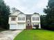 Two-story house with two-car garage and landscaping at 3393 Madison Farm Way, Snellville, GA 30039