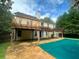 Home's back features a deck, pergola, and pool at 3393 Madison Farm Way, Snellville, GA 30039