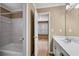 Bathroom with tiled shower/tub combo, white vanity, and view of the adjacent bedroom at 5061 Belair Bluff Se Ct, Mableton, GA 30126