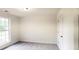 Simple bedroom with window, closet, and neutral walls at 4205 Old House Dr, Conley, GA 30288