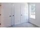 Spacious bedroom with double doors and window at 4205 Old House Dr, Conley, GA 30288