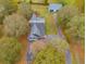 Aerial view of house, barn, and surrounding trees at 210 Pine Valley Rd, Hiram, GA 30141