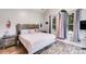 Main bedroom with king-size bed, wood headboard, and large window at 210 Pine Valley Rd, Hiram, GA 30141