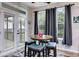Charming breakfast nook with a round table and four teal chairs near sliding doors at 210 Pine Valley Rd, Hiram, GA 30141