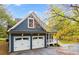 Two-car garage with white doors and gray exterior at 210 Pine Valley Rd, Hiram, GA 30141