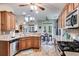Open kitchen with island, wood cabinets, and stainless steel appliances at 210 Pine Valley Rd, Hiram, GA 30141