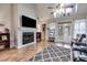 Spacious living room boasts a fireplace, hardwood floors, and lots of natural light at 210 Pine Valley Rd, Hiram, GA 30141