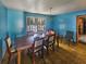 Dining room with blue walls, wood table, and chairs at 8347 Hilltop Rd, Jonesboro, GA 30236