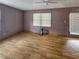 Living room with mauve walls, wood flooring and sliding glass door at 8347 Hilltop Rd, Jonesboro, GA 30236