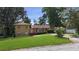 Ranch style house with a red door and nicely landscaped lawn at 8347 Hilltop Rd, Jonesboro, GA 30236