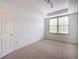 Bright bedroom featuring carpeted floors and a window with blinds at 1735 Peachtree Ne St # 321, Atlanta, GA 30309