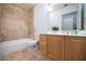 Clean bathroom with tile flooring, bathtub, and wooden vanity at 1735 Peachtree Ne St # 321, Atlanta, GA 30309