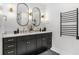 Bathroom with double vanity, black cabinets, and gold fixtures at 310 Conyers Rd, Mcdonough, GA 30253