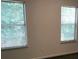 Bedroom with two windows and neutral walls at 5632 Stonington Trace Pkwy, Stone Mountain, GA 30087