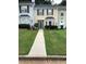 Two-story townhouse with green lawn and walkway at 5632 Stonington Trace Pkwy, Stone Mountain, GA 30087