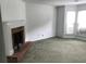 Spacious living room featuring a brick fireplace and large windows at 5632 Stonington Trace Pkwy, Stone Mountain, GA 30087