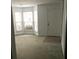 Bright living room with bay windows and carpet at 5632 Stonington Trace Pkwy, Stone Mountain, GA 30087