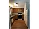 Galley kitchen with wood cabinets and linoleum flooring at 5632 Stonington Trace Pkwy, Stone Mountain, GA 30087