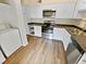 Updated kitchen features stainless steel appliances and wood-look flooring at 502 Brandywine Cir, Atlanta, GA 30350