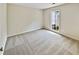 Bright bedroom featuring neutral carpeting and a window at 502 Brandywine Cir, Atlanta, GA 30350