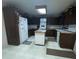 Galley kitchen with white appliances and wood cabinets at 3749 Centerville Rosebud Rd, Snellville, GA 30039