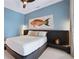 Main bedroom with a large bed and calming blue walls at 775 Juniper Ne St # 612, Atlanta, GA 30308