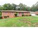 Brick Ranch house with attached garage and landscaping at 3542 Lynfield Sw Dr, Atlanta, GA 30311