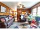 Living room with wood paneling, leather furniture, and wood floors at 3542 Lynfield Sw Dr, Atlanta, GA 30311