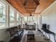 Relaxing sunroom with wicker furniture, ceiling fan, and plenty of natural light at 100 Williams Blf, Mcdonough, GA 30252