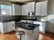 Kitchen with white cabinets, granite island, and hardwood floors at , Atlanta, GA 30318