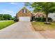 Brick home with a two-car garage and landscaped yard at 5501 Somer Ridge Ct, Douglasville, GA 30134
