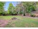 Landscaped backyard with a water fountain feature at 5501 Somer Ridge Ct, Douglasville, GA 30134