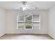 Bright dining room features large window with backyard view and ceiling fan at 5501 Somer Ridge Ct, Douglasville, GA 30134