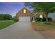 Brick house with a two-car garage and manicured lawn at 5501 Somer Ridge Ct, Douglasville, GA 30134