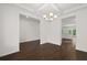 Open concept dining room with hardwood floors and kitchen view at 1698 Lacebark Elm Way, Lawrenceville, GA 30045