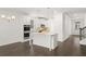 Modern kitchen with white cabinets, granite island, and stainless steel appliances at 1698 Lacebark Elm Way, Lawrenceville, GA 30045
