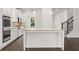 Modern kitchen with white cabinets, granite island, and stainless steel appliances at 1698 Lacebark Elm Way, Lawrenceville, GA 30045