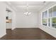 Spacious dining room featuring hardwood floors and a modern chandelier at 1698 Lacebark Elm Way, Lawrenceville, GA 30045