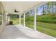 Covered patio with ceiling fan, overlooking grassy backyard at 1698 Lacebark Elm Way, Lawrenceville, GA 30045