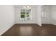 Bright dining room with hardwood floors and large window at 1698 Lacebark Elm Way, Lawrenceville, GA 30045