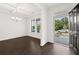 Bright dining room with hardwood floors and chandelier, view to front yard at 1698 Lacebark Elm Way, Lawrenceville, GA 30045