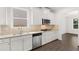 Modern kitchen with white cabinets, granite countertops, and stainless steel appliances at 1698 Lacebark Elm Way, Lawrenceville, GA 30045
