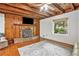 Living room with hardwood floors, a stone fireplace, and exposed wooden beams at 2841 Upper Sweetwater Se Trl, White, GA 30184
