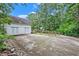 Large concrete driveway with a rustic stone border and trees at 2841 Upper Sweetwater Se Trl, White, GA 30184