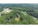 Aerial view of property showing homes and wooded area at 2841 Upper Sweetwater Se Trl, White, GA 30184